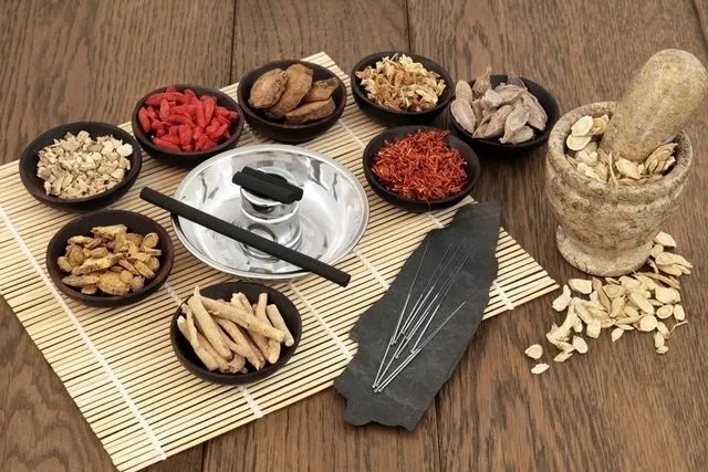 A table with bowls of food and chopsticks.