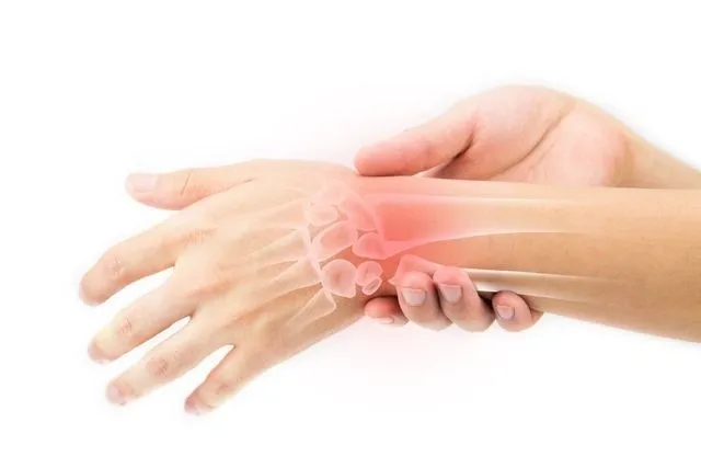 A person with their hands and wrist in pain.